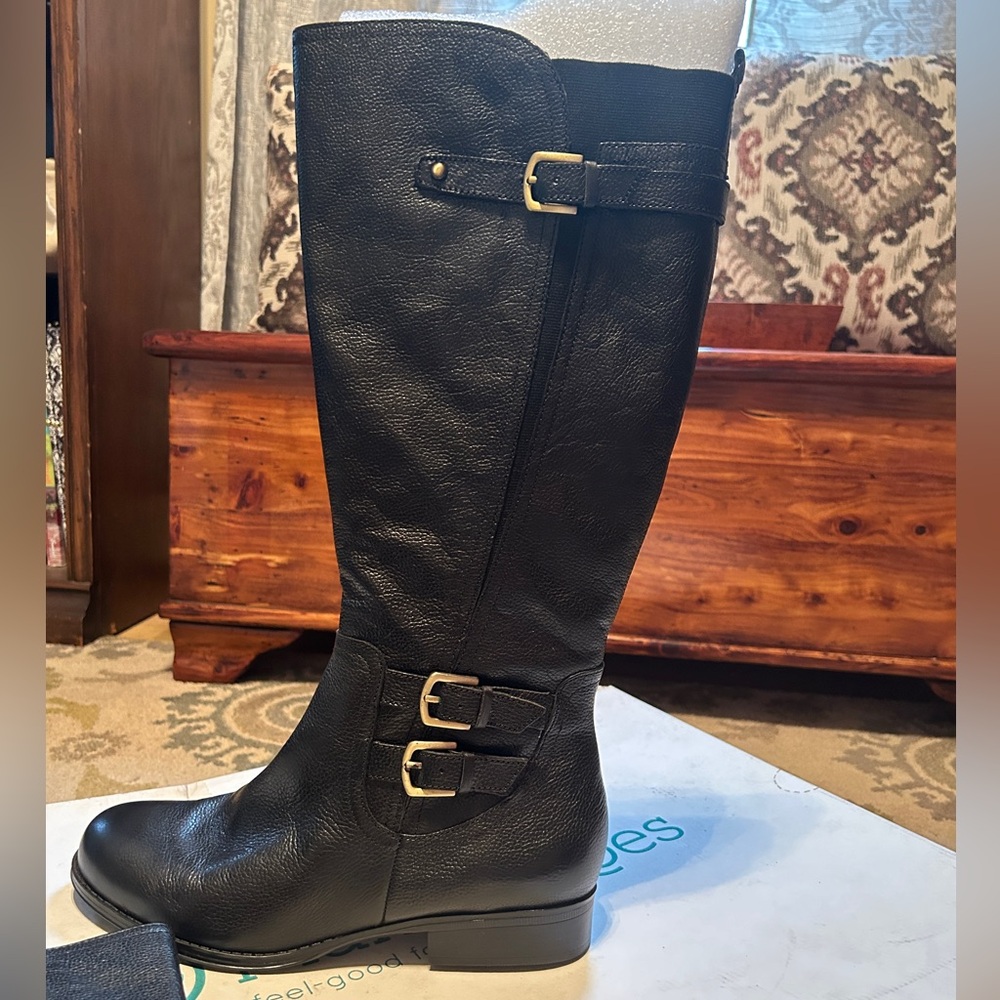 Brand new, never used. Size 10 tall black boot. From planetshoes.com